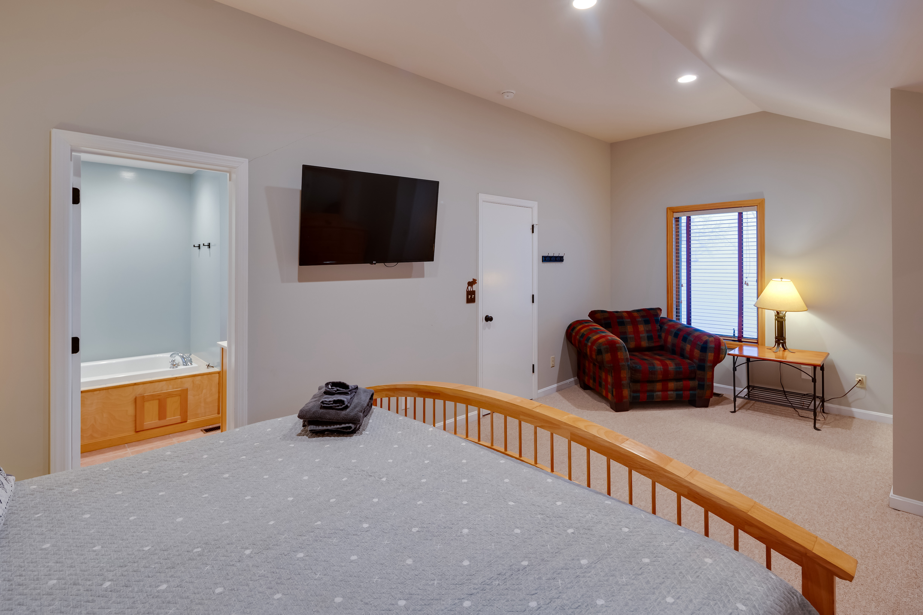 King bed with jetted tub visible